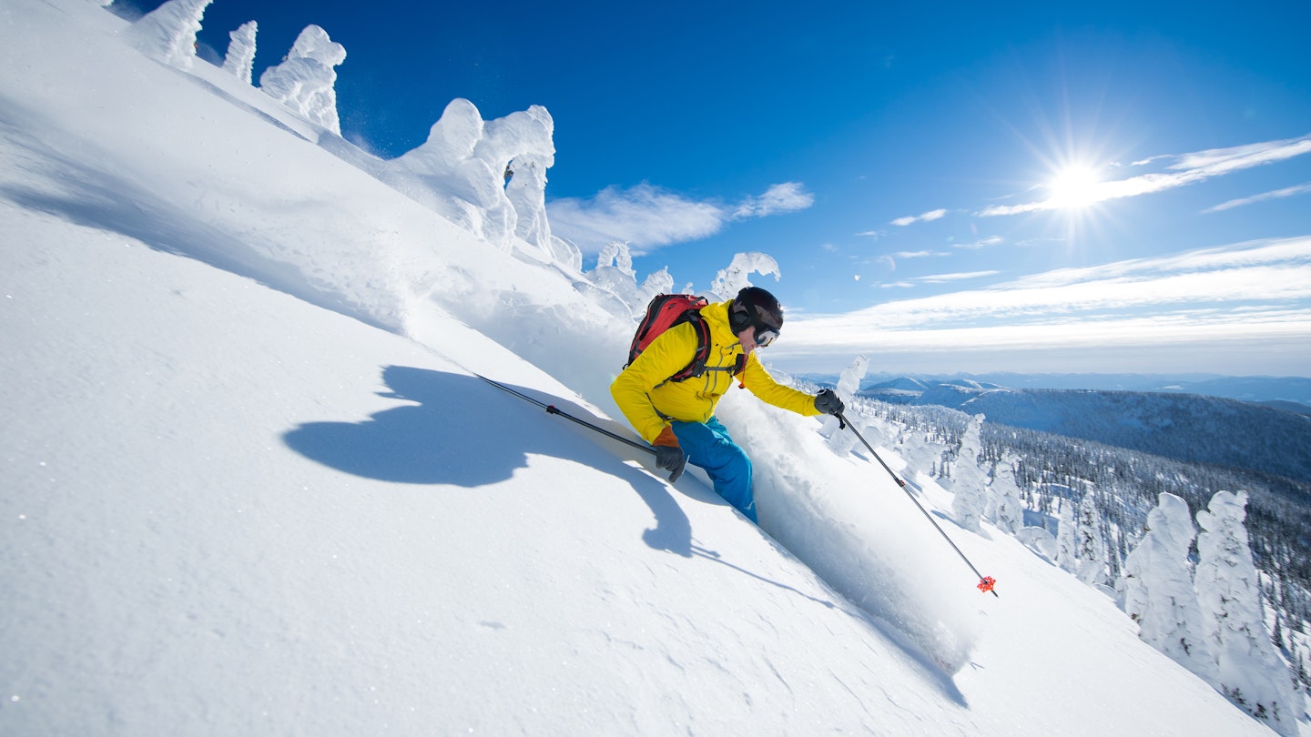 A skier in British Columbia in Canada in bright sunshine.