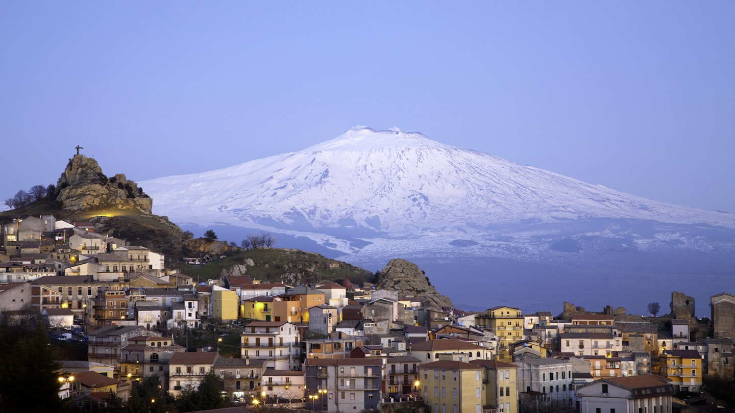 View of the village of San Teodoro and Etna volcano on background. Sicily, Italy.
141215014
Mediterranean Countries, Residential Building, Building Exterior, Twilight, Scenics, Idyllic, Blue, Italian Culture, Urban Scene, Panoramic, Sicily, Italy, Sunset, Mt Etna, Volcano, Mountain, Sky, Snow, House, Built Structure, Urban Skyline, Cityscape, Village, Town, Symbol
Etna Volcano - stock photo
View of the village of San Teodoro and Etna volcano on background. Sicily, Italy.